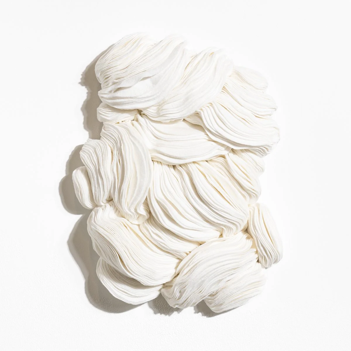 natural fabric textile wall sculpture in organic shapes by Sienna Marts @ Soapbox Arts Gallery in Burlington, Vermont