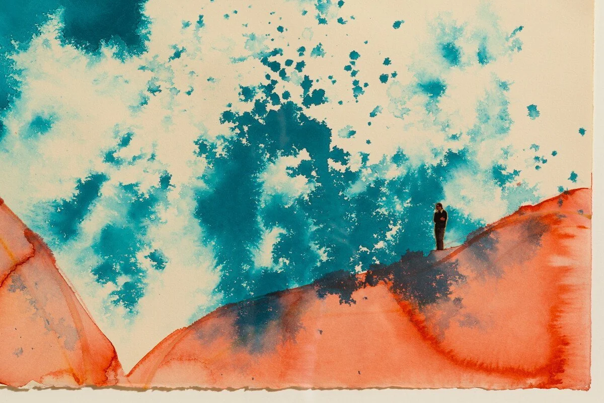 Original mixed media collage by Burlington-based artist, Vanessa Compton, of two figures on abstract watercolor hills available at Soapbox Arts Gallery in Burlington, VT