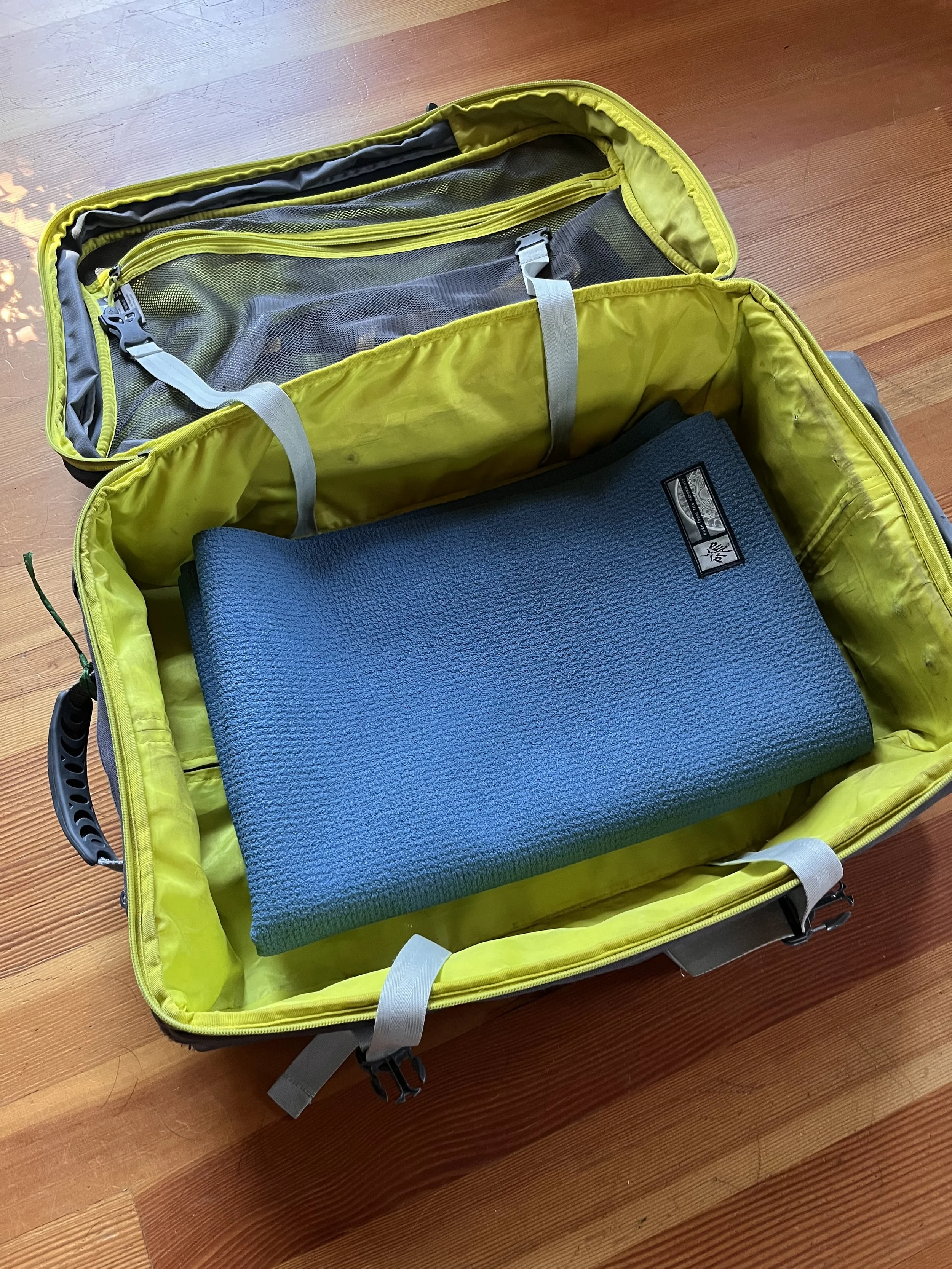 yoga mat folded into carry-on backpack for flying