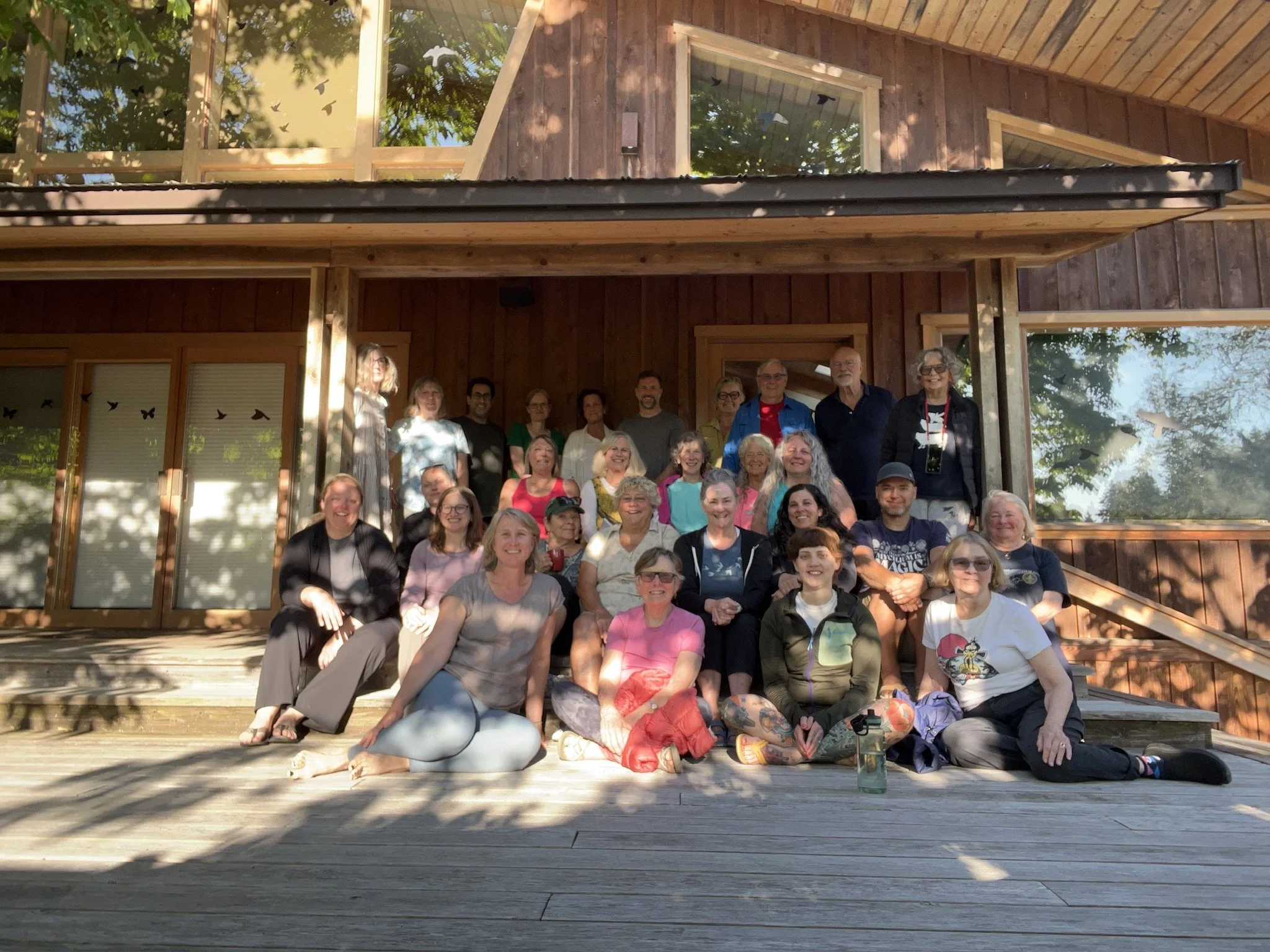 yoga retreat group sitting on the steps at stowel lake farm yoga retreat