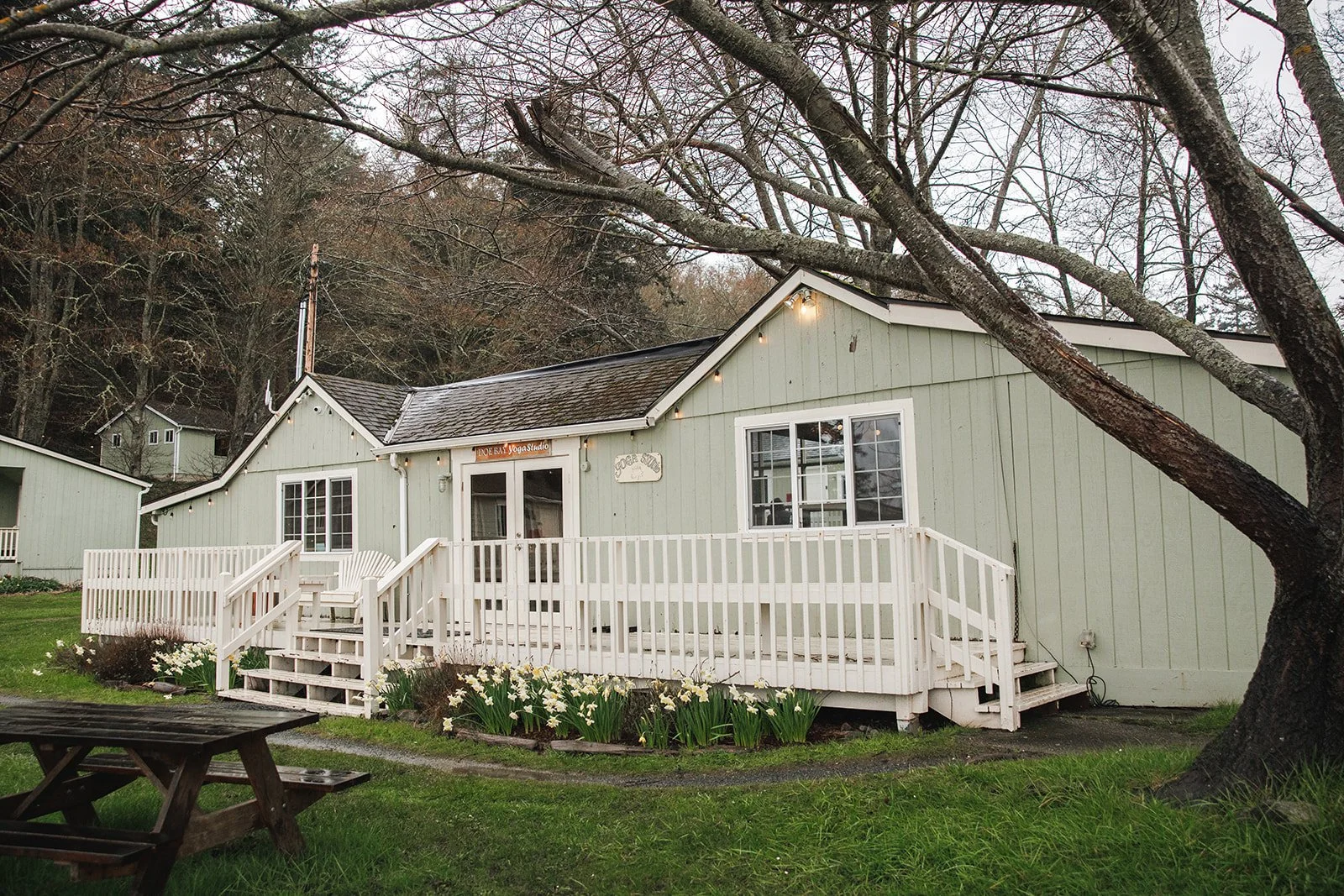 white clapperboard house with deck at orcas island yoga retreat