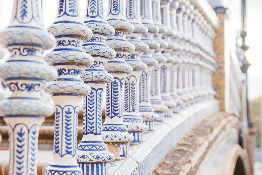 Blue painted details on the ceramic spindles of one of the bridges at Plaza de España in Seville, Spain.