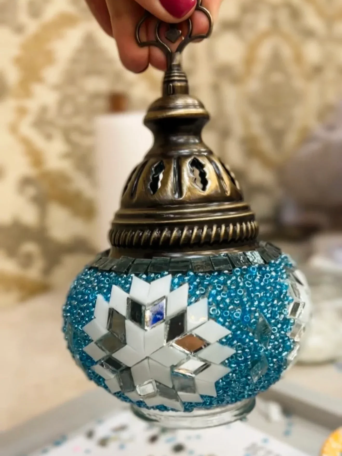 Turkish mosaic lamp with glass pieces and beads in a lamp making class.