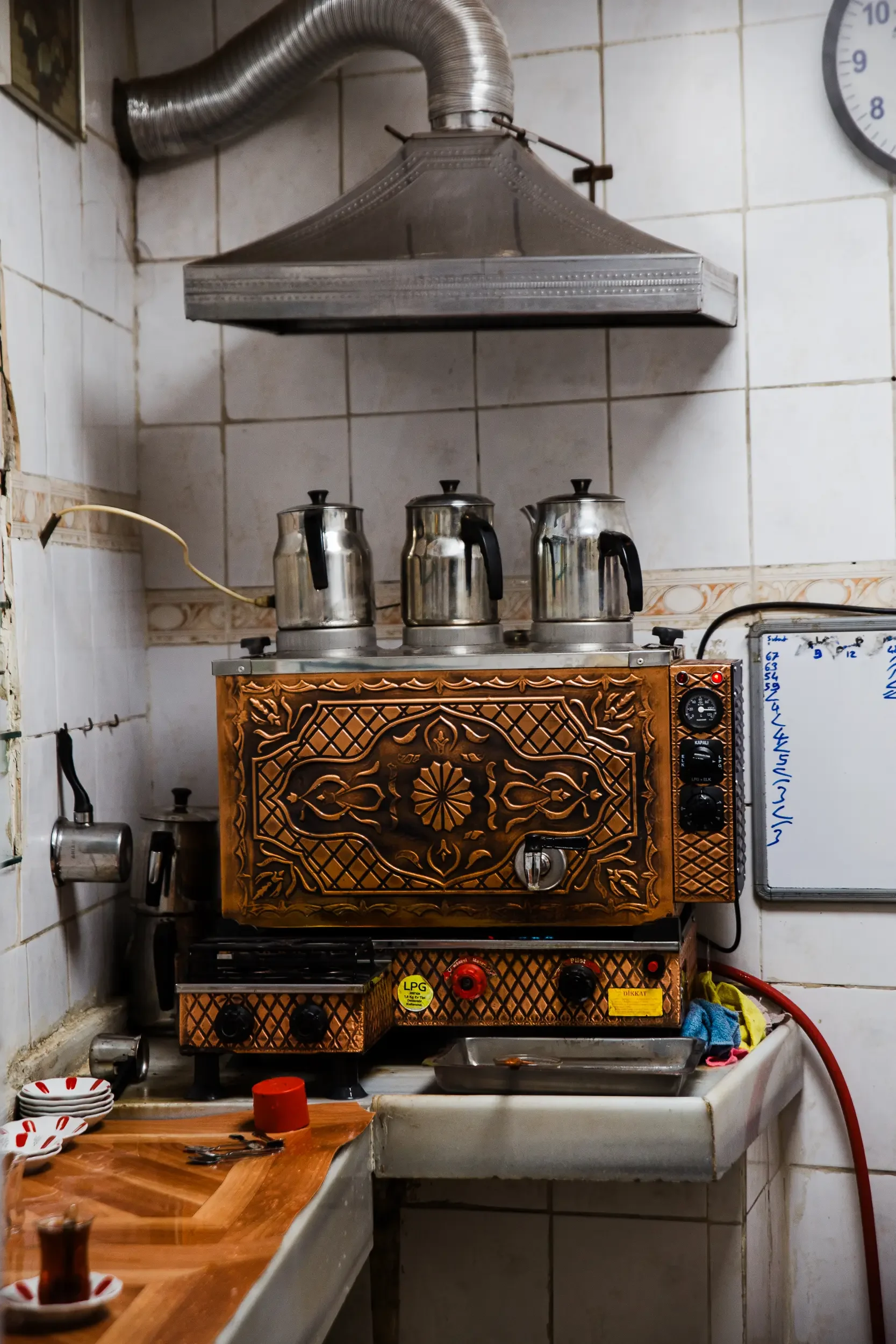 Tea shop on an Istanbul food tour, tea kettles on top of stove