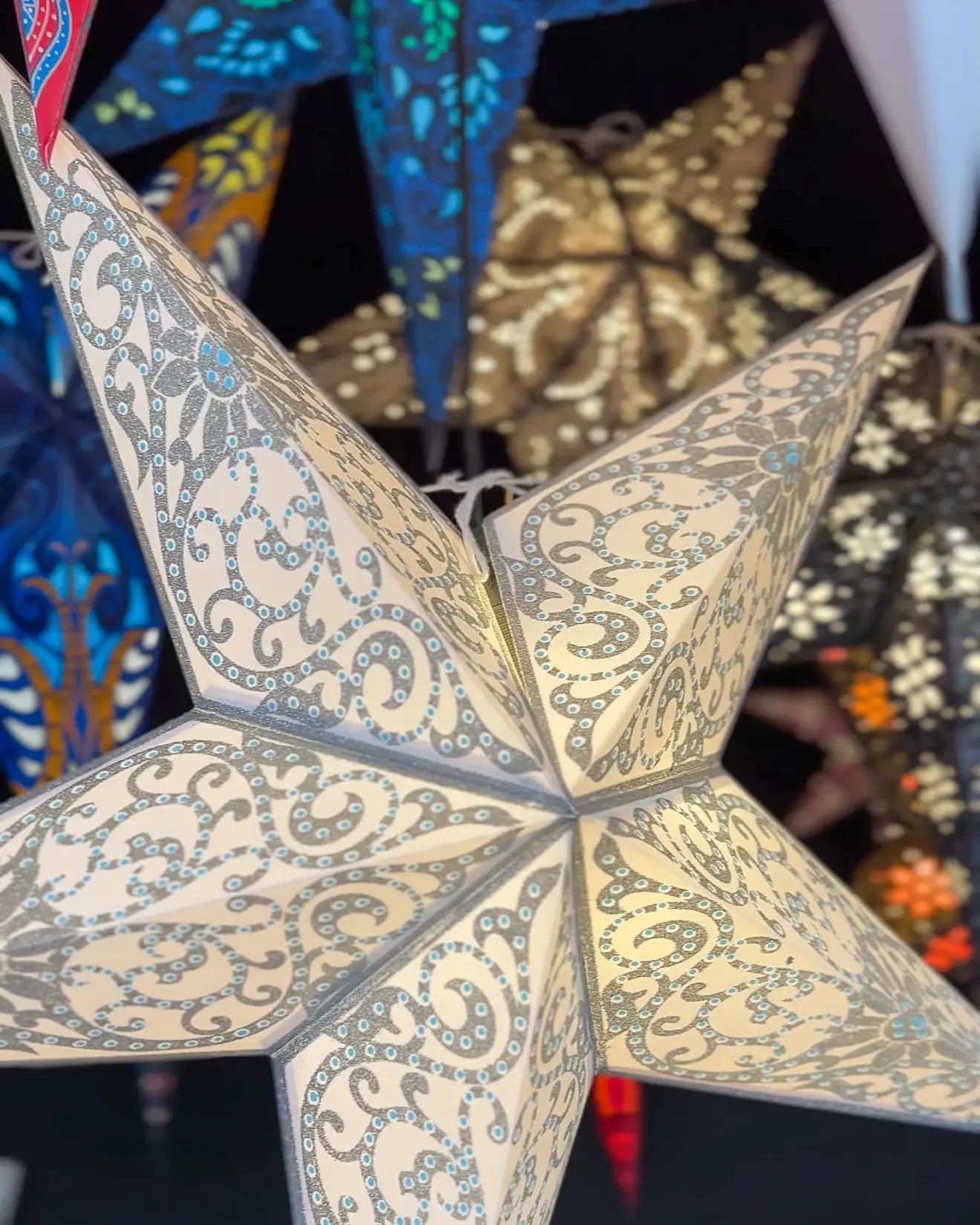 Closeup of paper Christmas star lanterns at a Christmas market in Germany