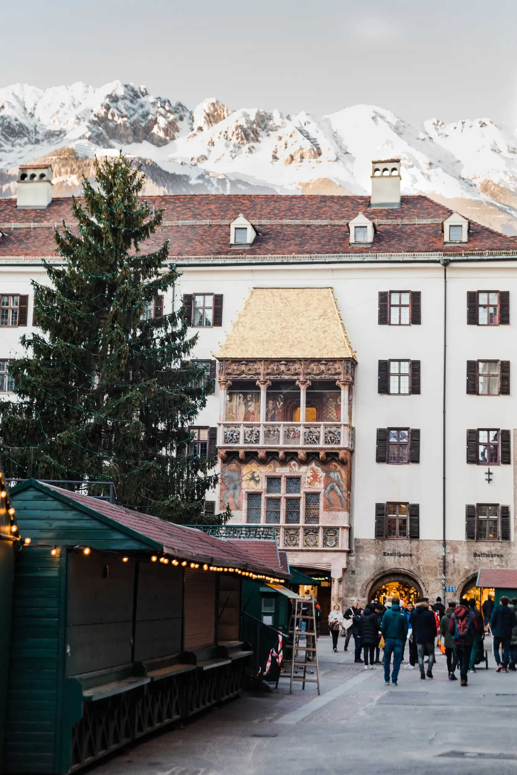 Innsbruck old town with golden roof, moutnain background and Christmas tree