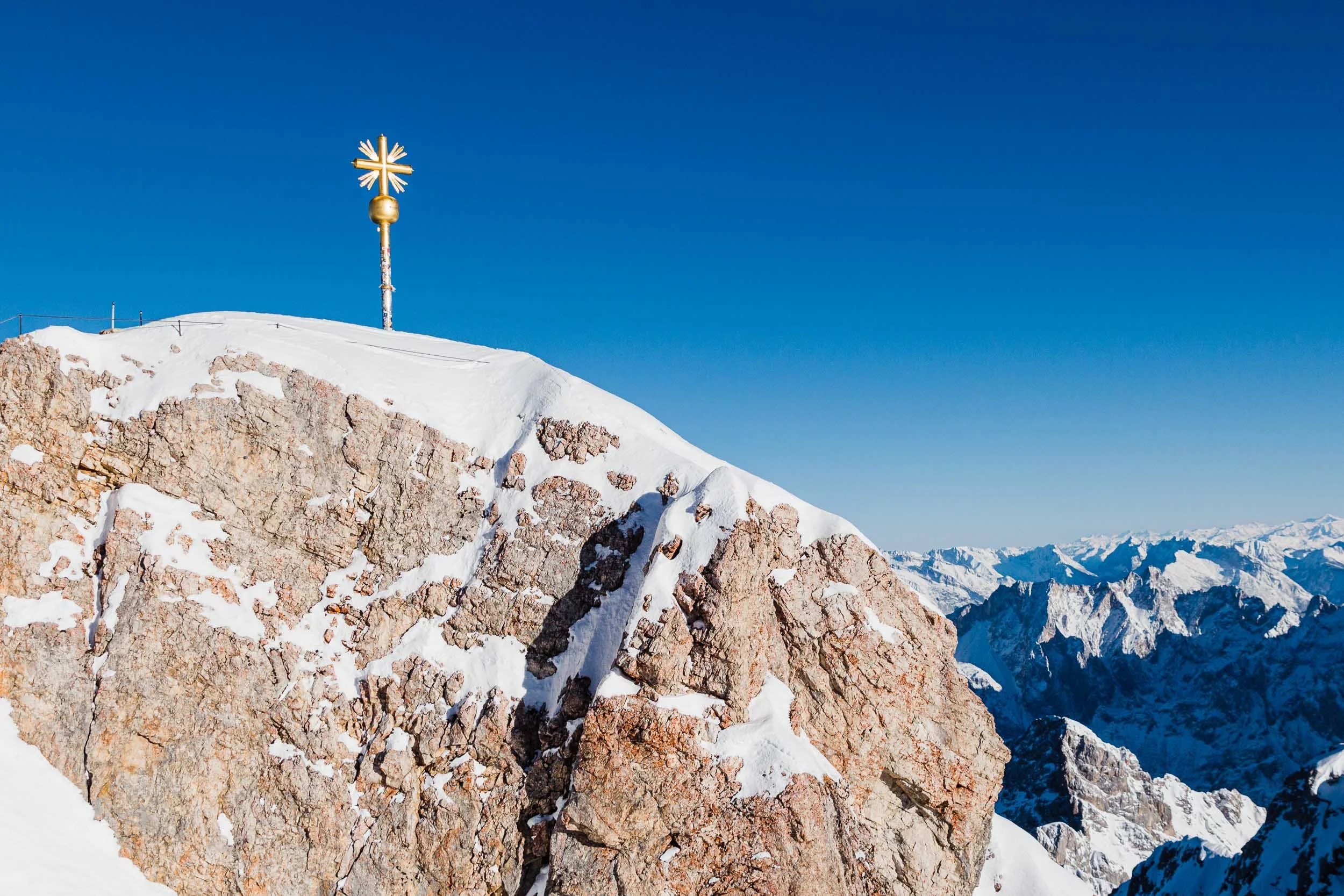 Snowy summit cross of the Zugspitze in Garmisch, Germany