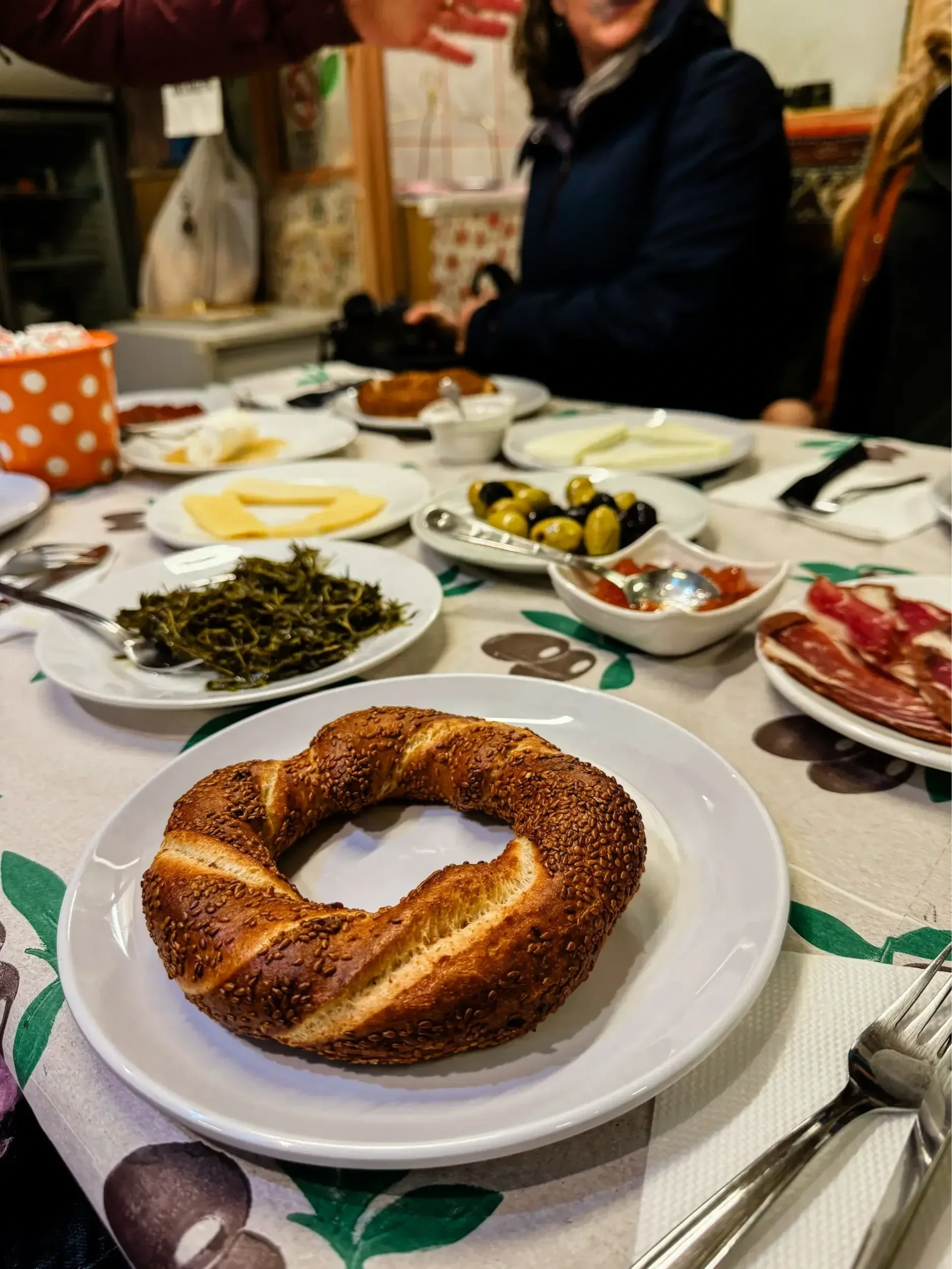 Turkish breakfast with simit, olives, cheese, and meat on a food tour in Istanbul