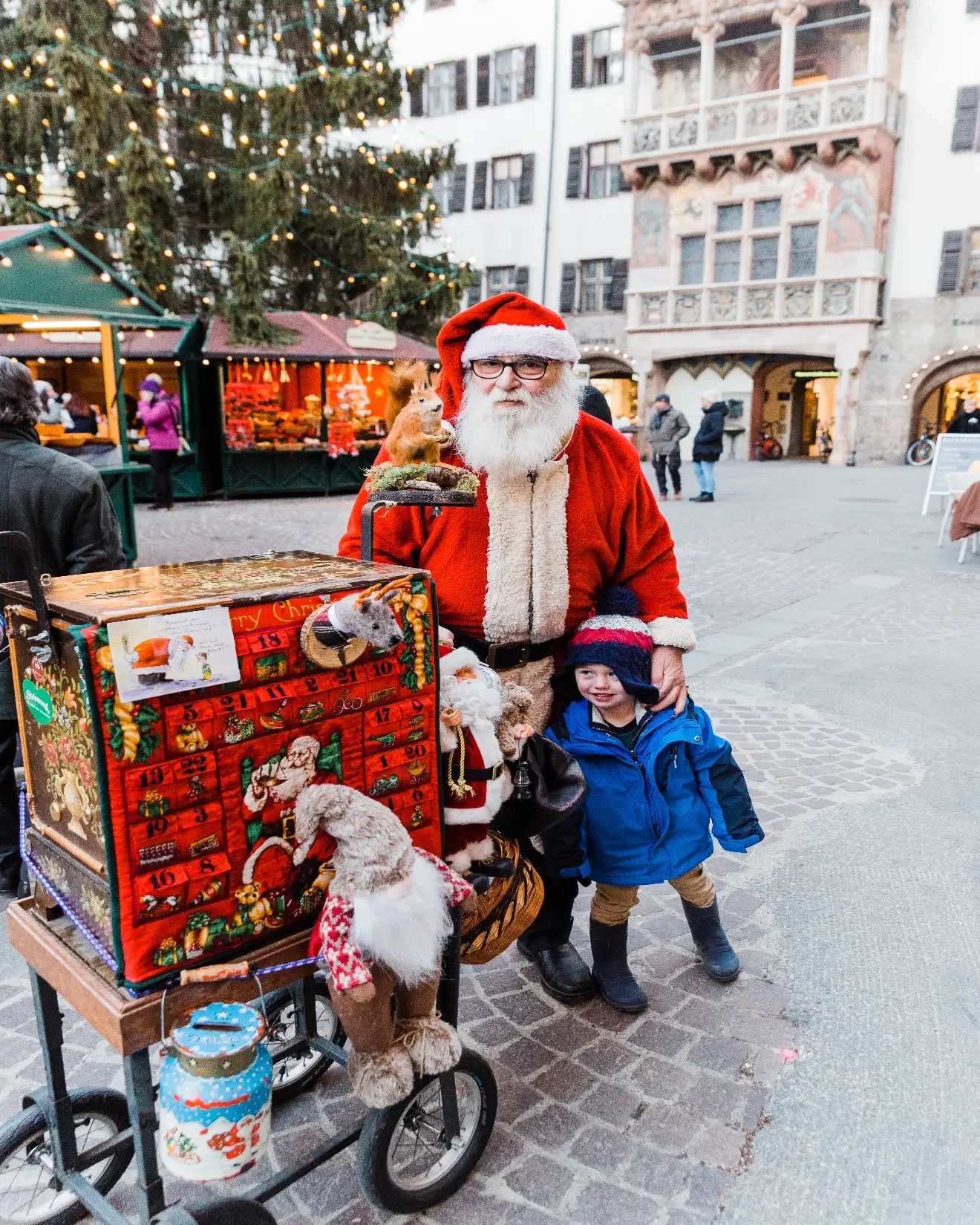 Little boy with Santa in the Christmas market of Innsbruck, Austria