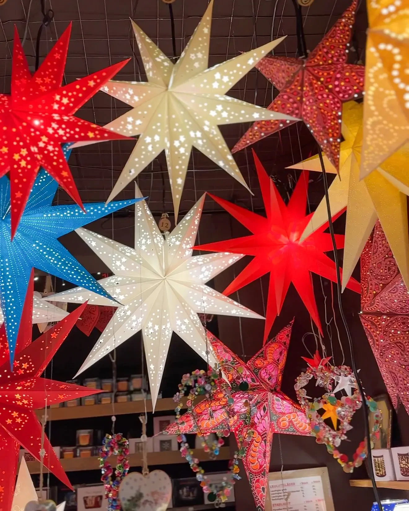 Colorful Christmas star lanterns hanging in a booth at a Christmas market in Germany