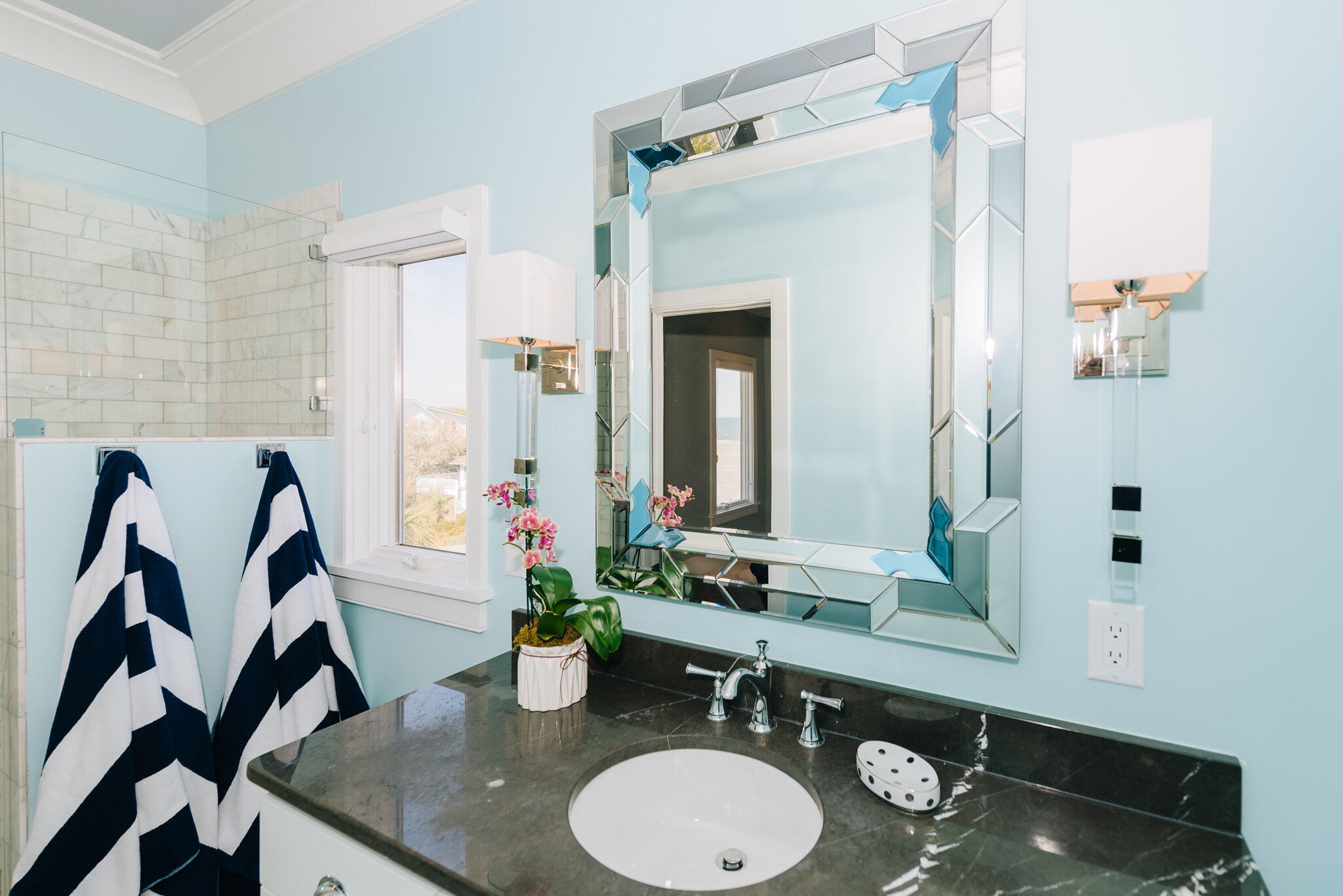 Dwell-Chic-Bright-Coastal-Home-Blue-Bathroom-Mirror-And-Sconces.jpg