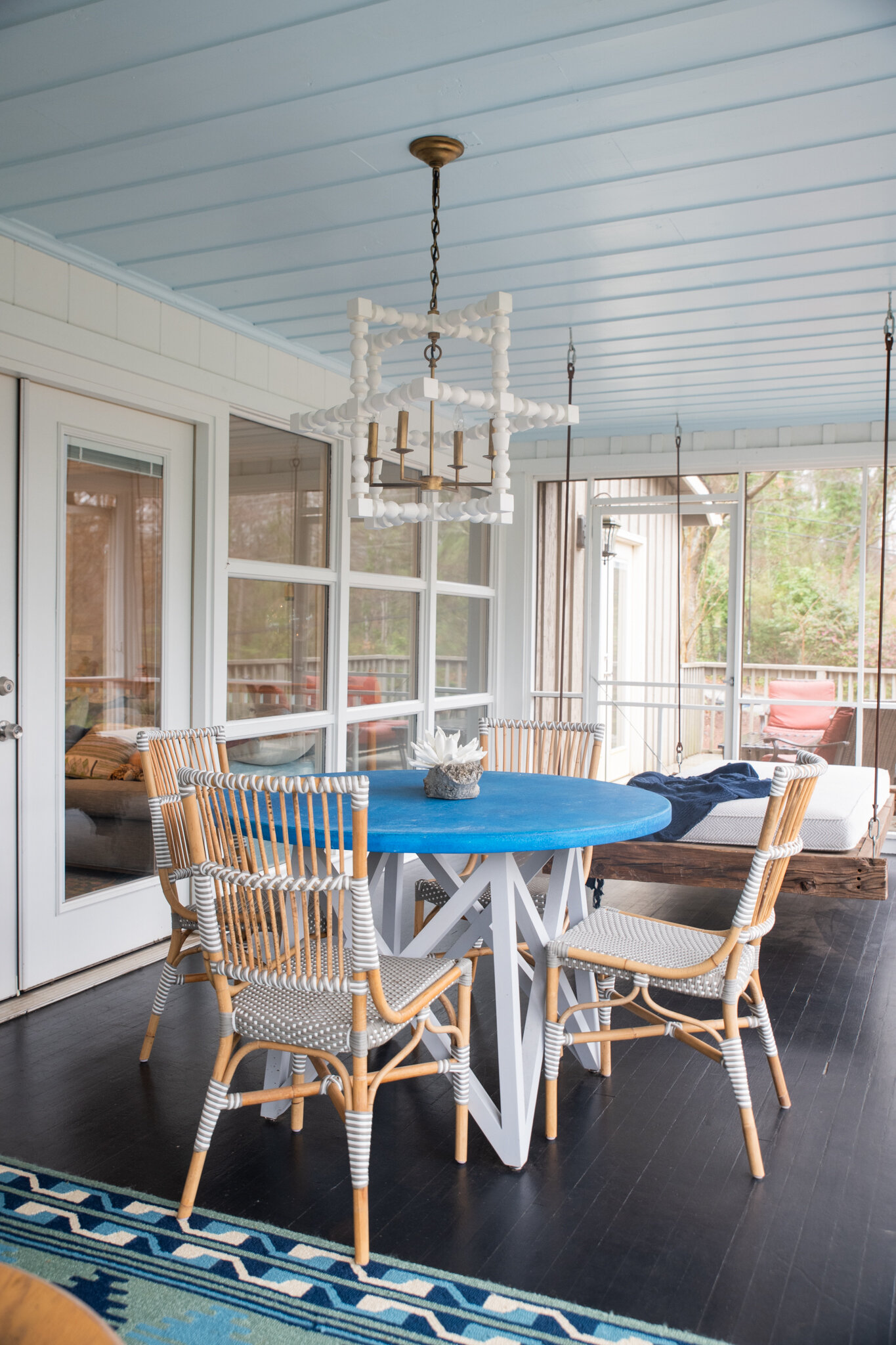 Dwell-Chic-Colorful-Coastal-Porch-Blue-Table-And-Swing.jpg