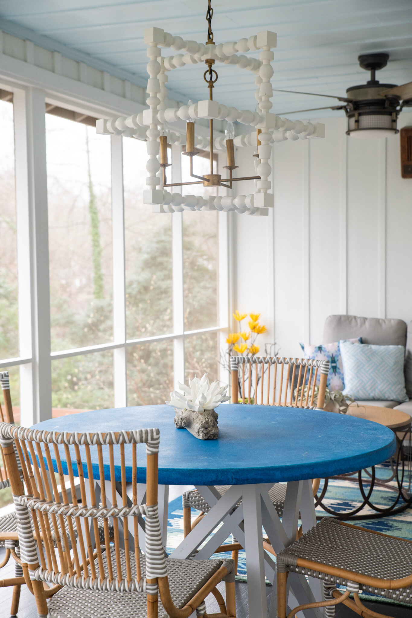 Dwell-Chic-Colorful-Coastal-Porch-Blue-Table-And-White-Chandelier.jpg