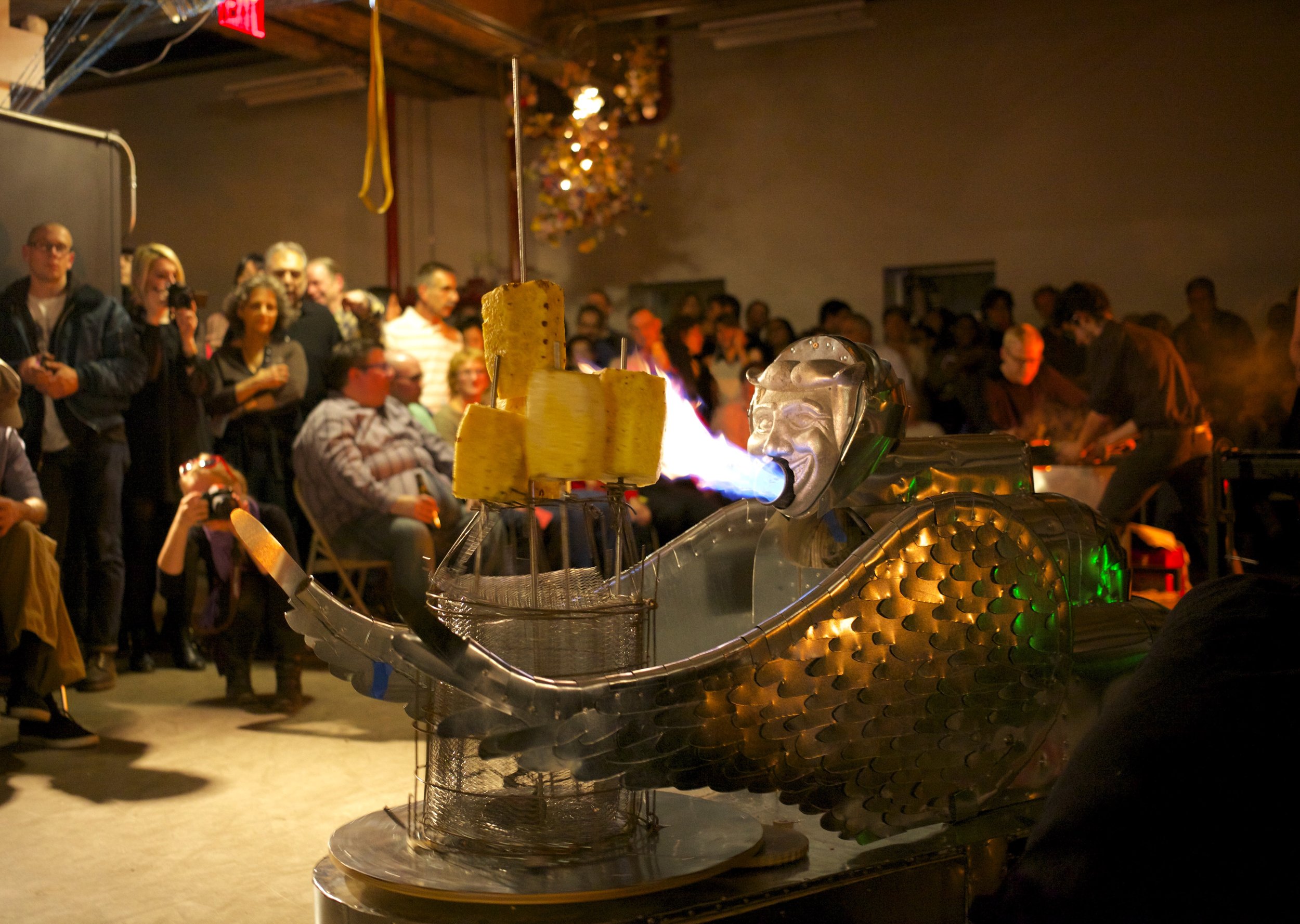Molded aluminum Coney Island Man Sphinx grilling pineapple by Sam Geer