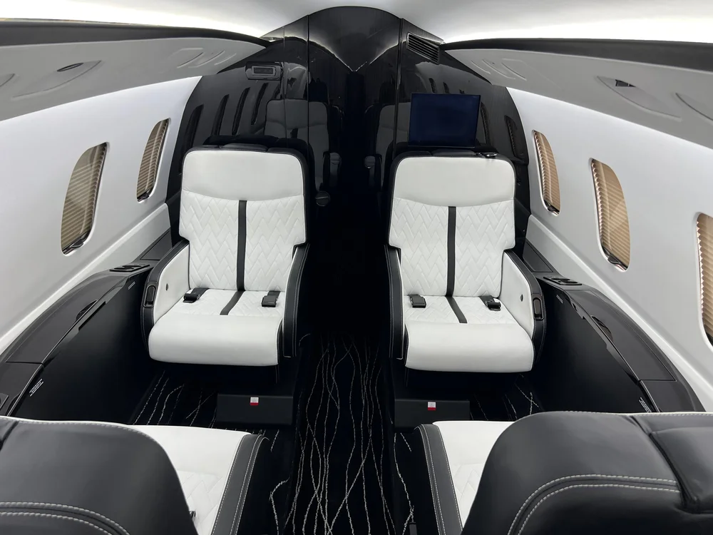 Refurbished business jet interior with leather seating and modern lighting