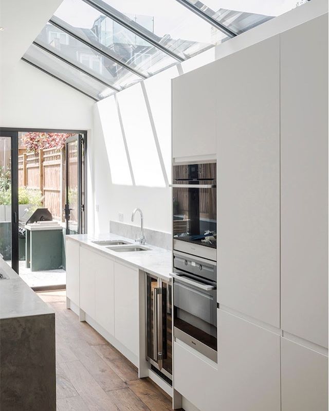 We dug a basement and extended into the garden to create a large kitchen, dining and a snug area - perfect for entertaining and family living. The Light well floods the space with light. The polished concrete island adds a gorgeous texture to the neu