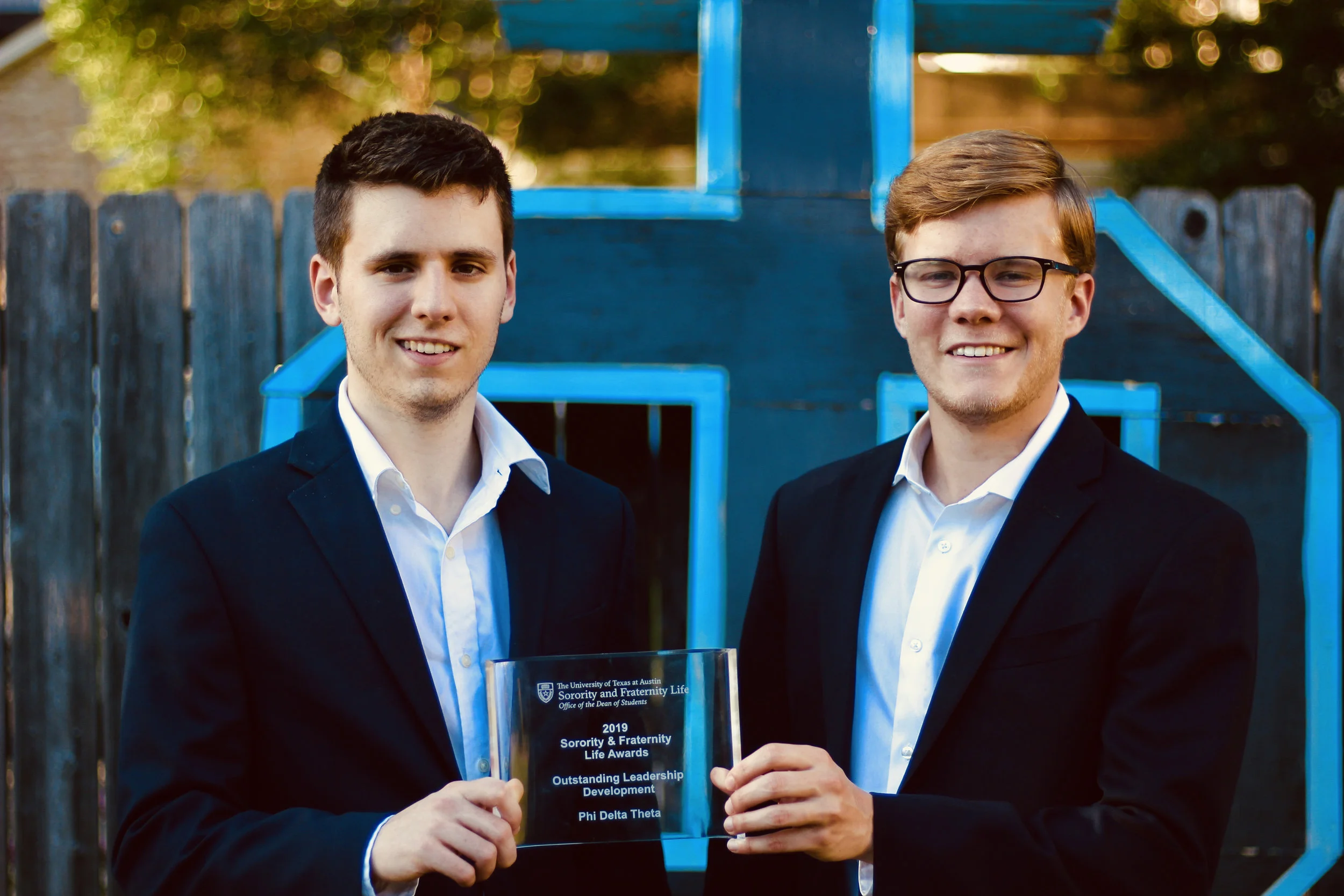 Awards Chairman Harrison White #2044 (left) returns to Phi Delta Theta with a new award after attending the Sorority & Fraternity Award ceremony. White presents the award to President Garrett Evanson #2016 (right).