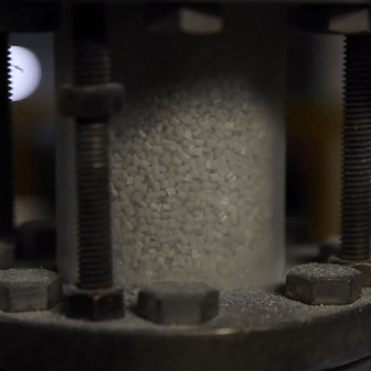 Recycled PET pellets extruded into filament fibers.