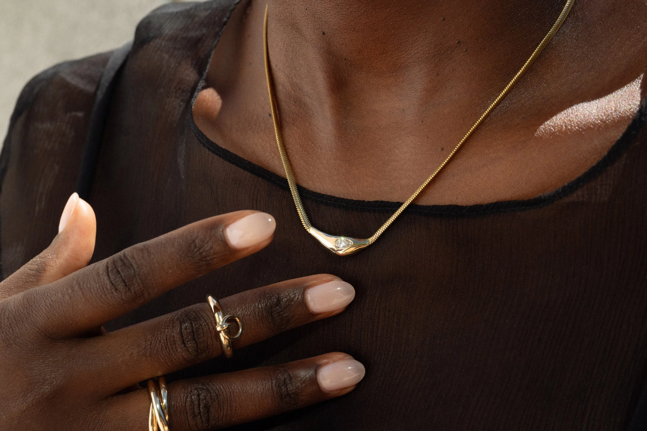 From left: Interconnection Ring, Interdependence Ring and the Where the Light Comes Through Necklace. 