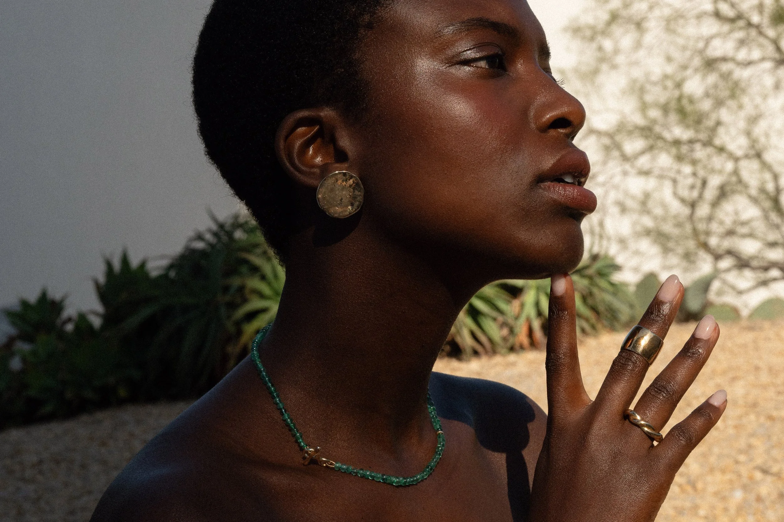 The Soleil Earrings and the Prayer Necklace are paired with the Conjuct Cigar and Helix Band.