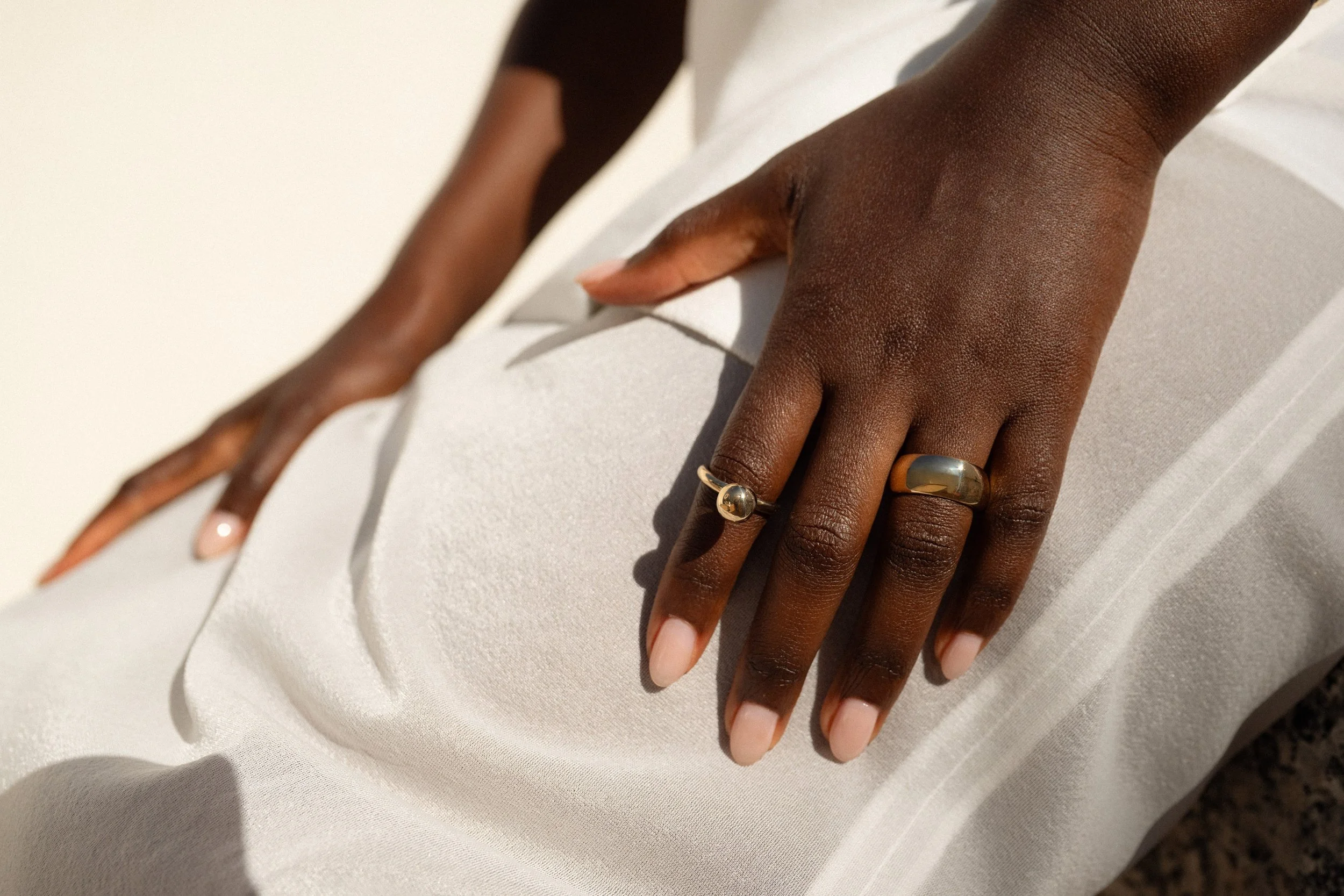 The Central Sun Ring and the Conjuct Cigar Band. Both handmade in recycled 14k gold using traditional lost-wax casting techniques.