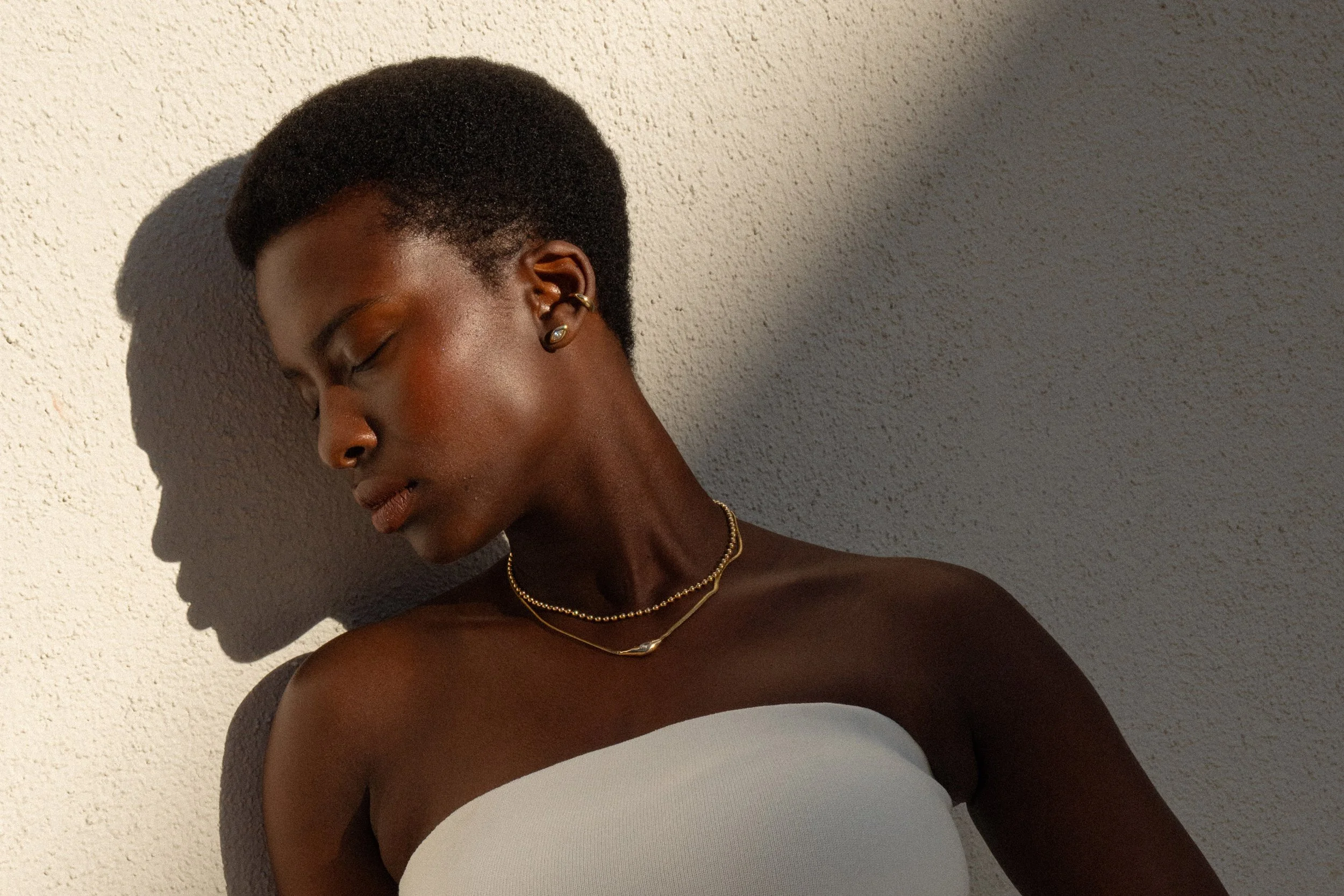 From top: Sybil Ear Cuff, marquis diamond Horus Studs, Gold Galaxy Chain and Where the Light Comes Through Necklace.