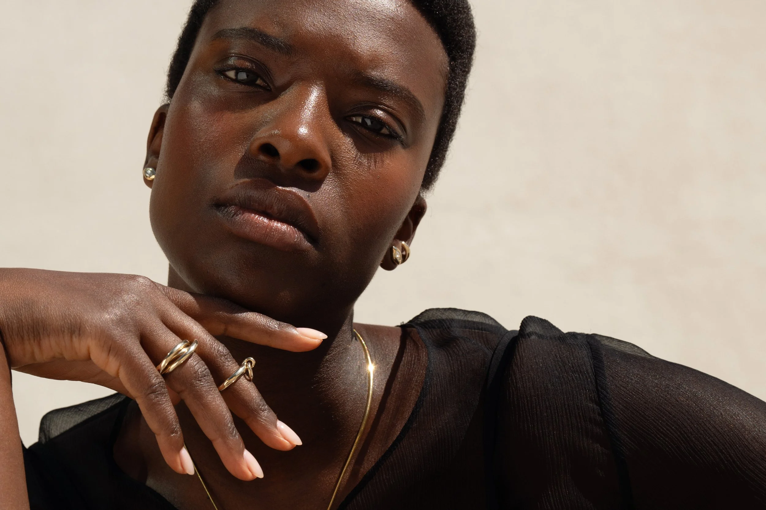 Anna wears the Sibyl Ear Cuff, Horus Studs with marquise diamonds. They are paired with the Interconnection Trio Ring and Interdependence Ring.