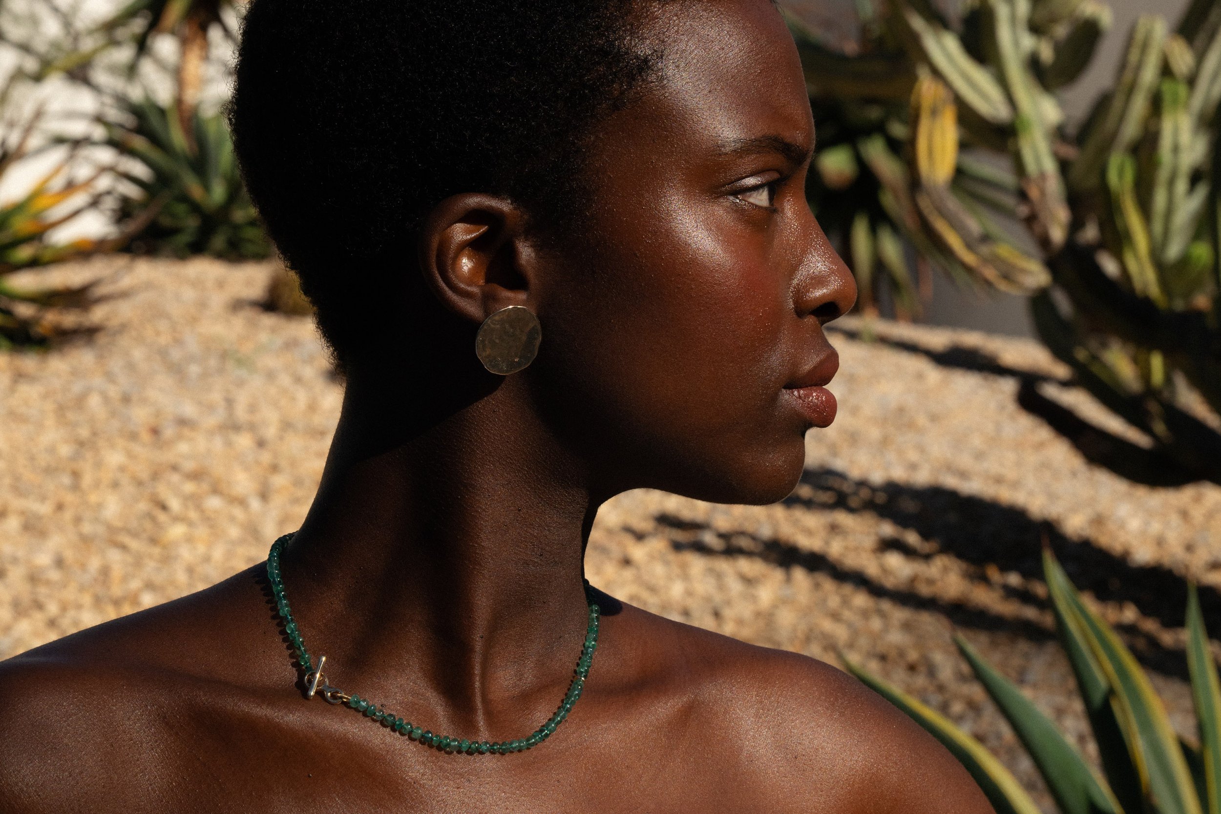 Anna wears the Soleil Earrings and Prayer Necklace in Emerald.