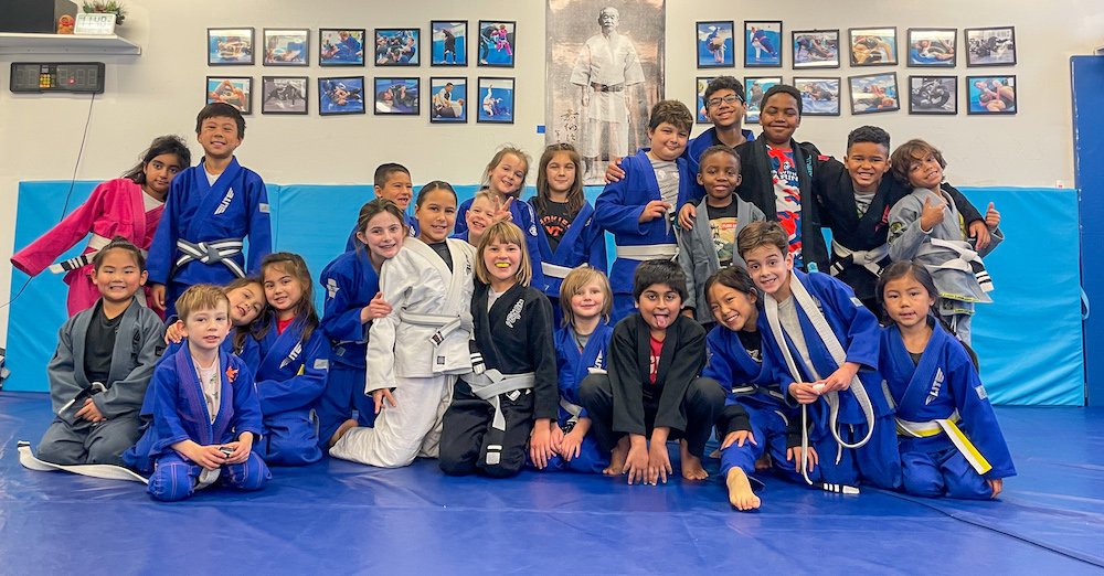 A group of kids after BJJ and Judo belt promotions