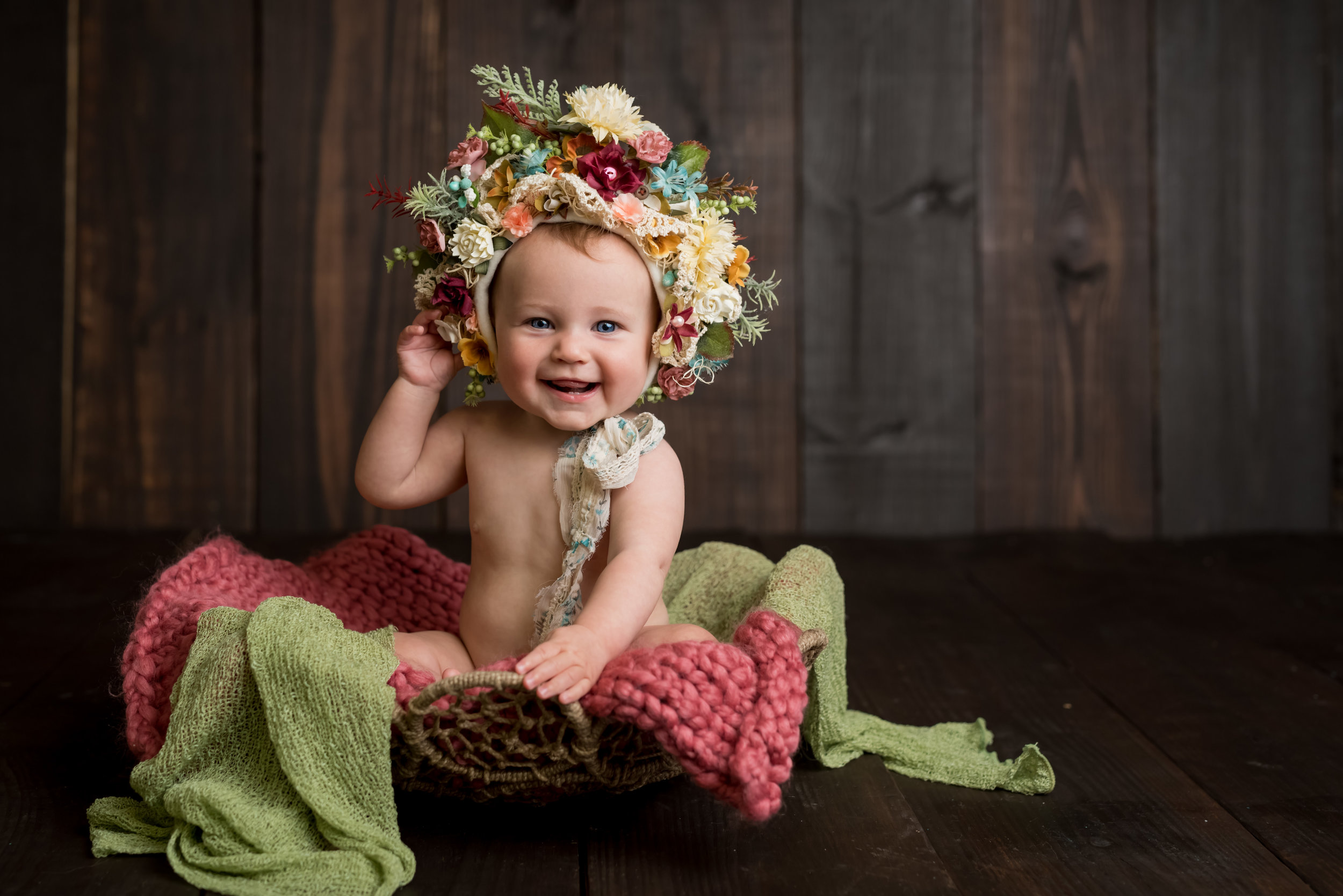 sitter session with junebug photography studio in manhattan, ks of a little girl in a flower bonnet