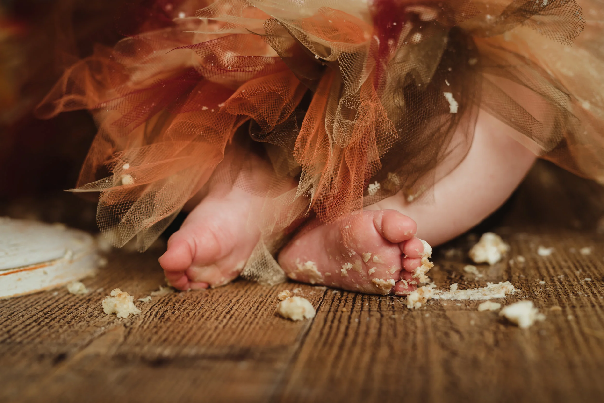 cute baby feet covered in cake with junebug photography studio in manhattan, ks