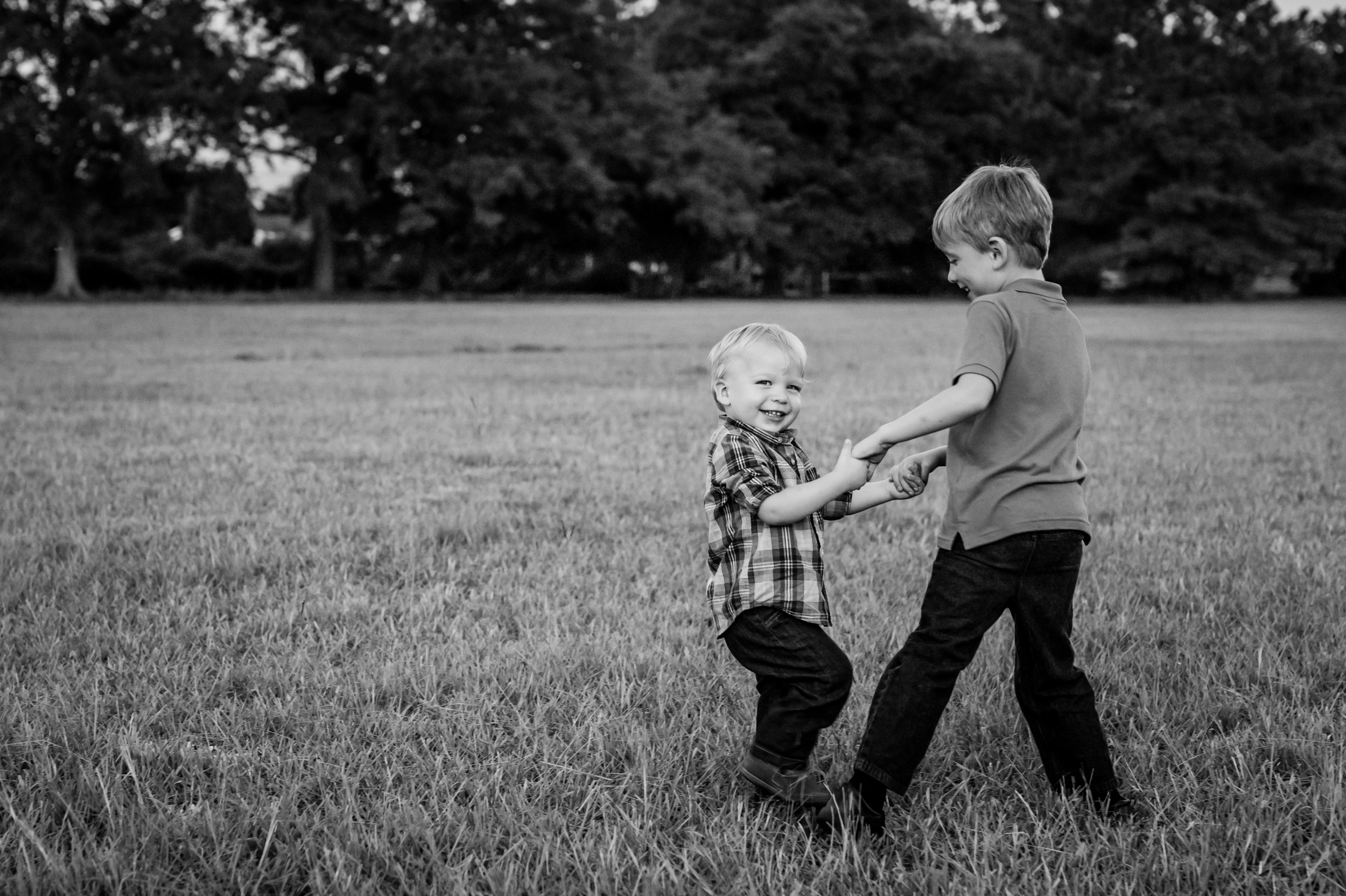 brothers playing ring around the rosey with junebug photography studio in manhattan, ks