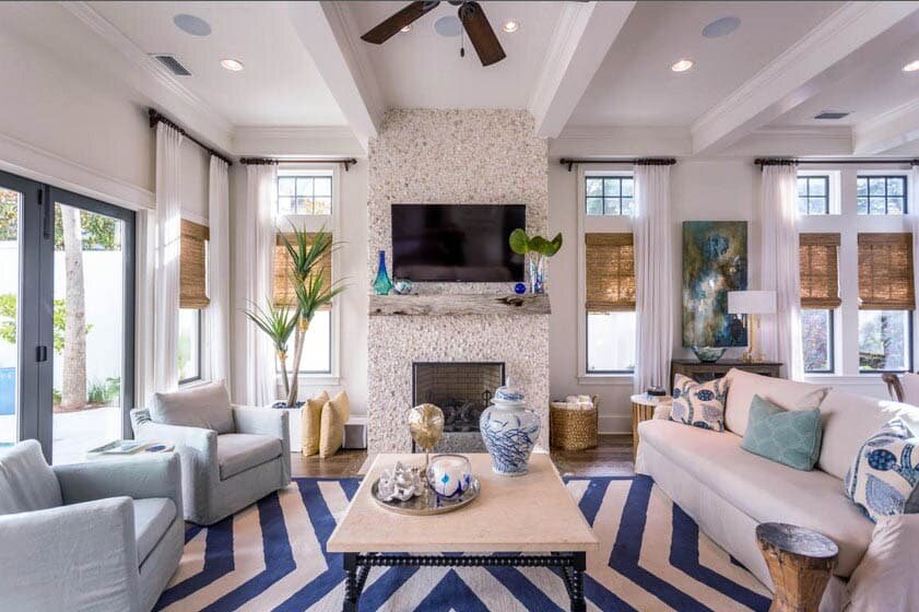 coastal-living-room-with-shell-fireplace-beam-ceiling-and-colorful-decor.jpg