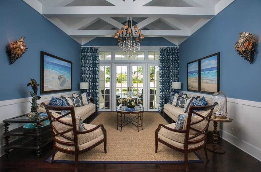 nautical-blue-themed-living-room-with-white-wainscoting-and-vaulted-ceiling.jpg