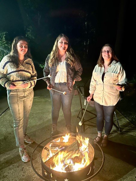 Emilee, Carolyn, and Jenna making S'mores!