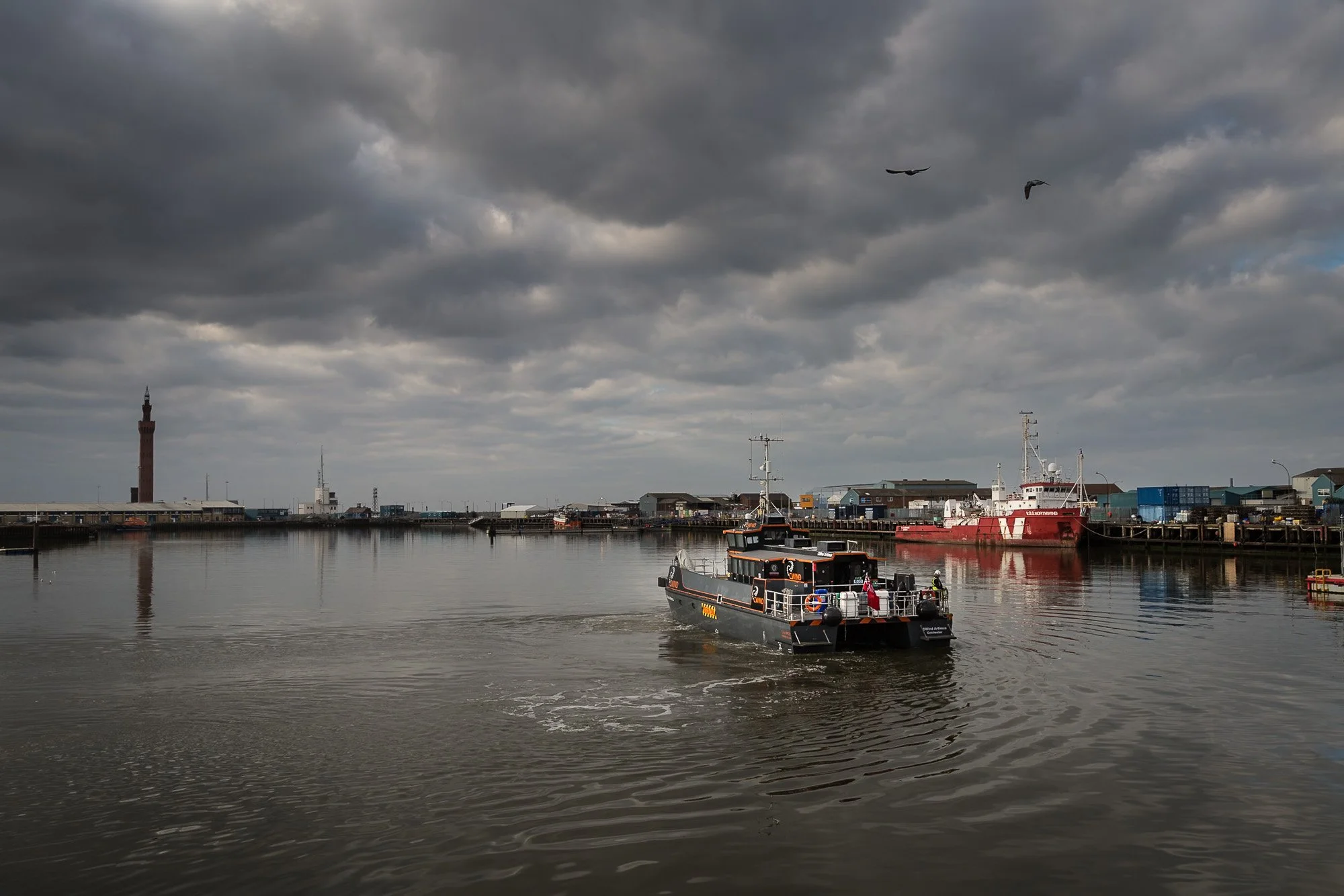 In its heyday, Grimsby fish dock was so full of fishing boats you could walk from one side to the other on their decks. Now, most of the vessels here are maintenance and construction craft for offshore wind farms