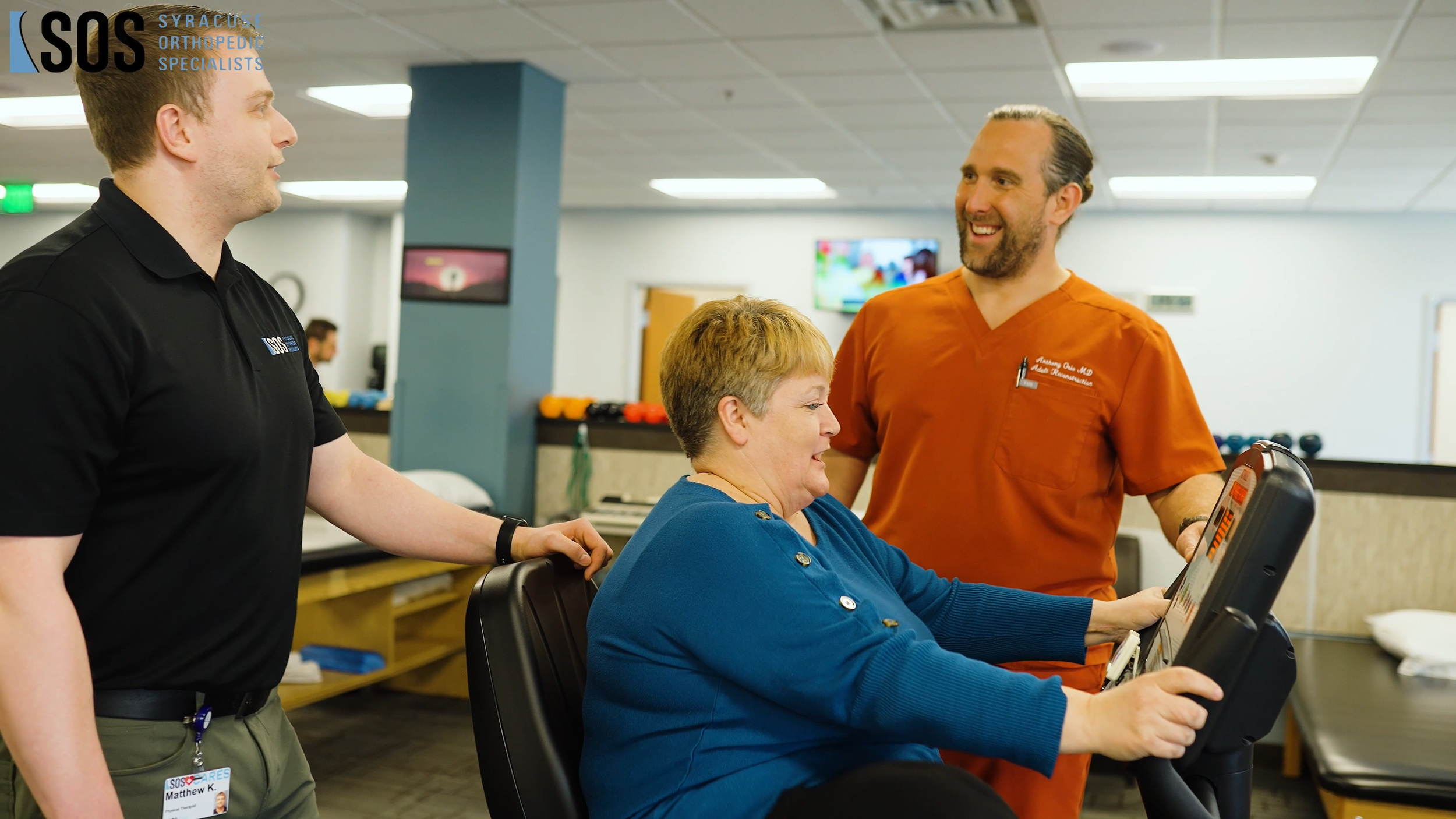 Orio Talking to patient on Bike with therapist matt