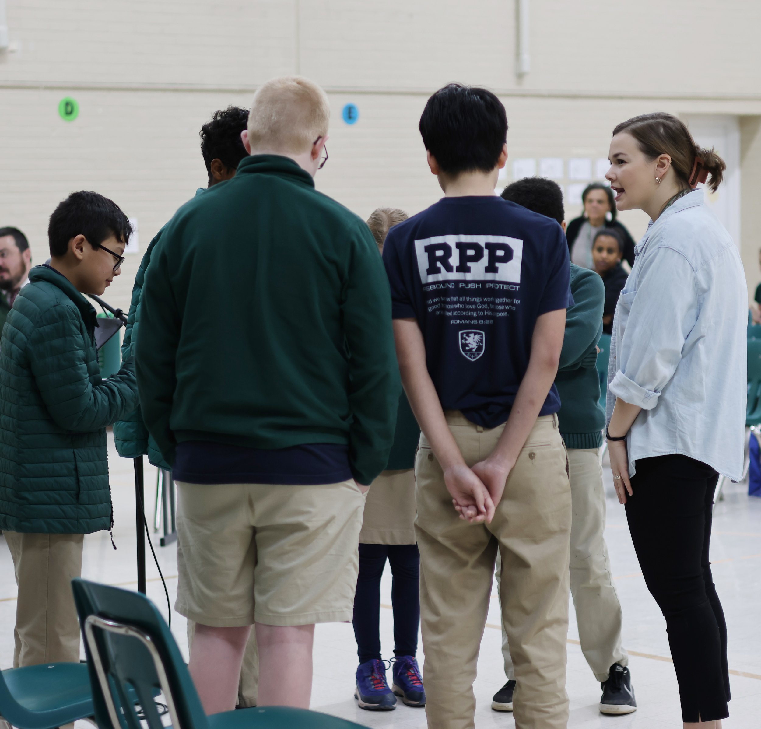 Mrs. Wiggins giving the contestants some last minute instructions and encouragement