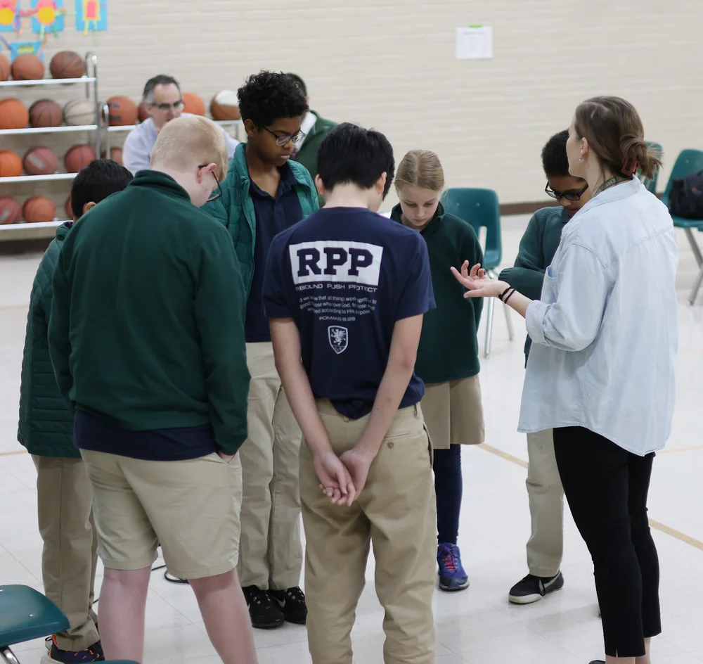 Praying with the students before beginning