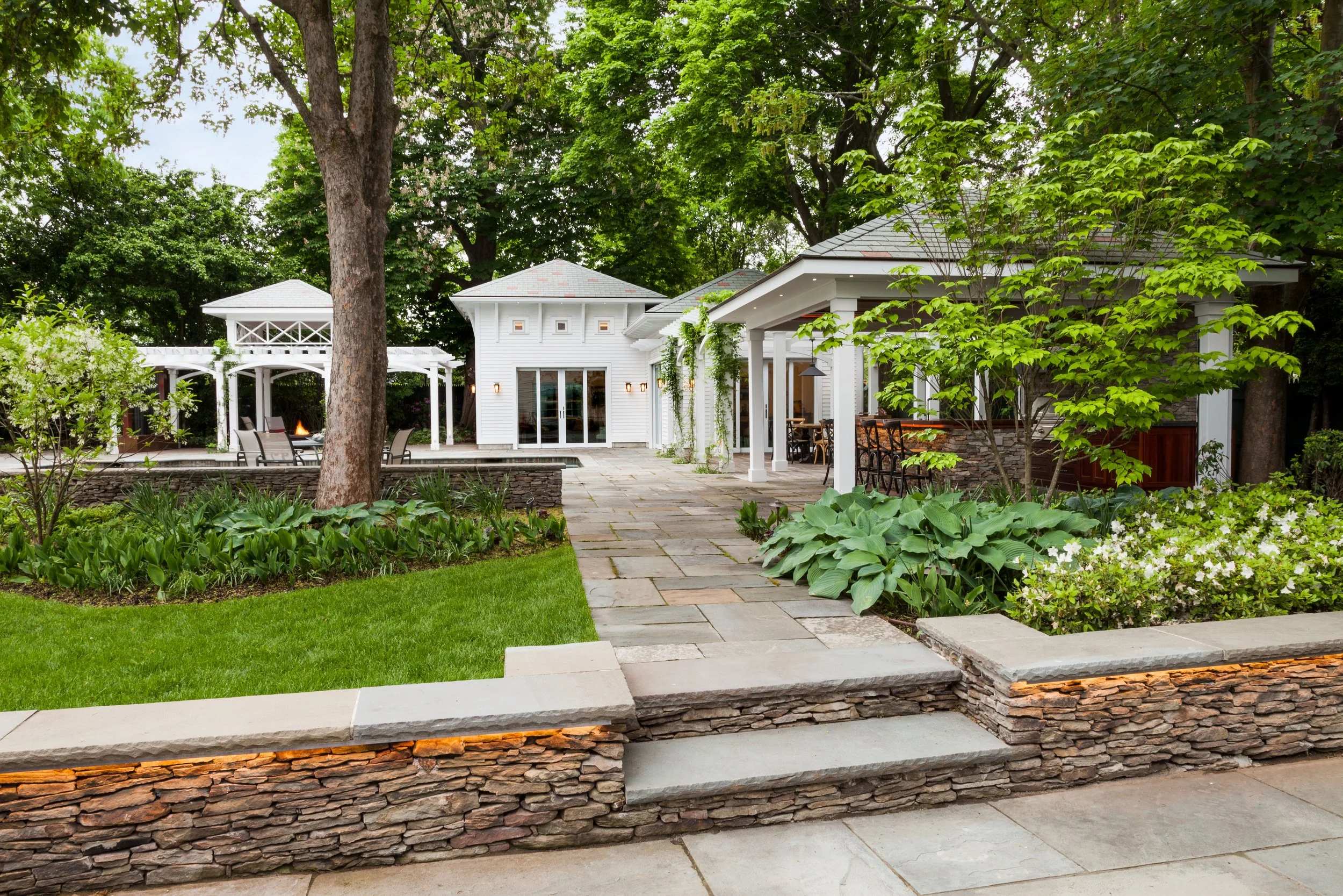 How Retaining Walls and Outdoor Lighting Work Together in Weston, MA Backyards