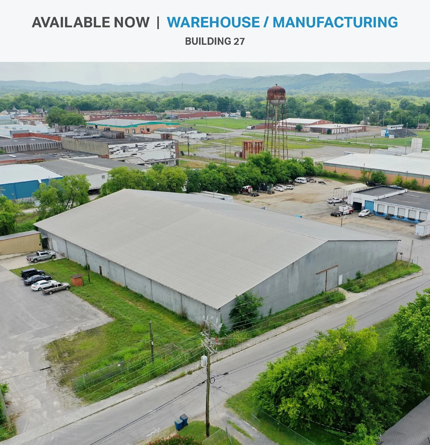 Building 27 aerial view showing large warehouse building with perimeter security fence