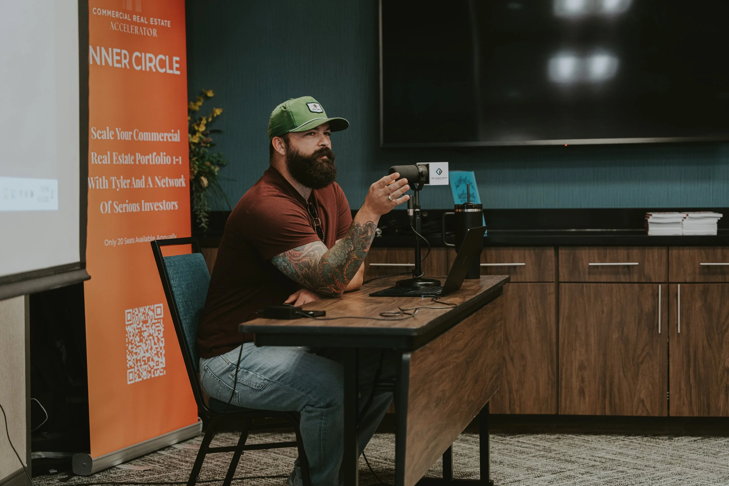 Tyler Cauble speaking at a desk