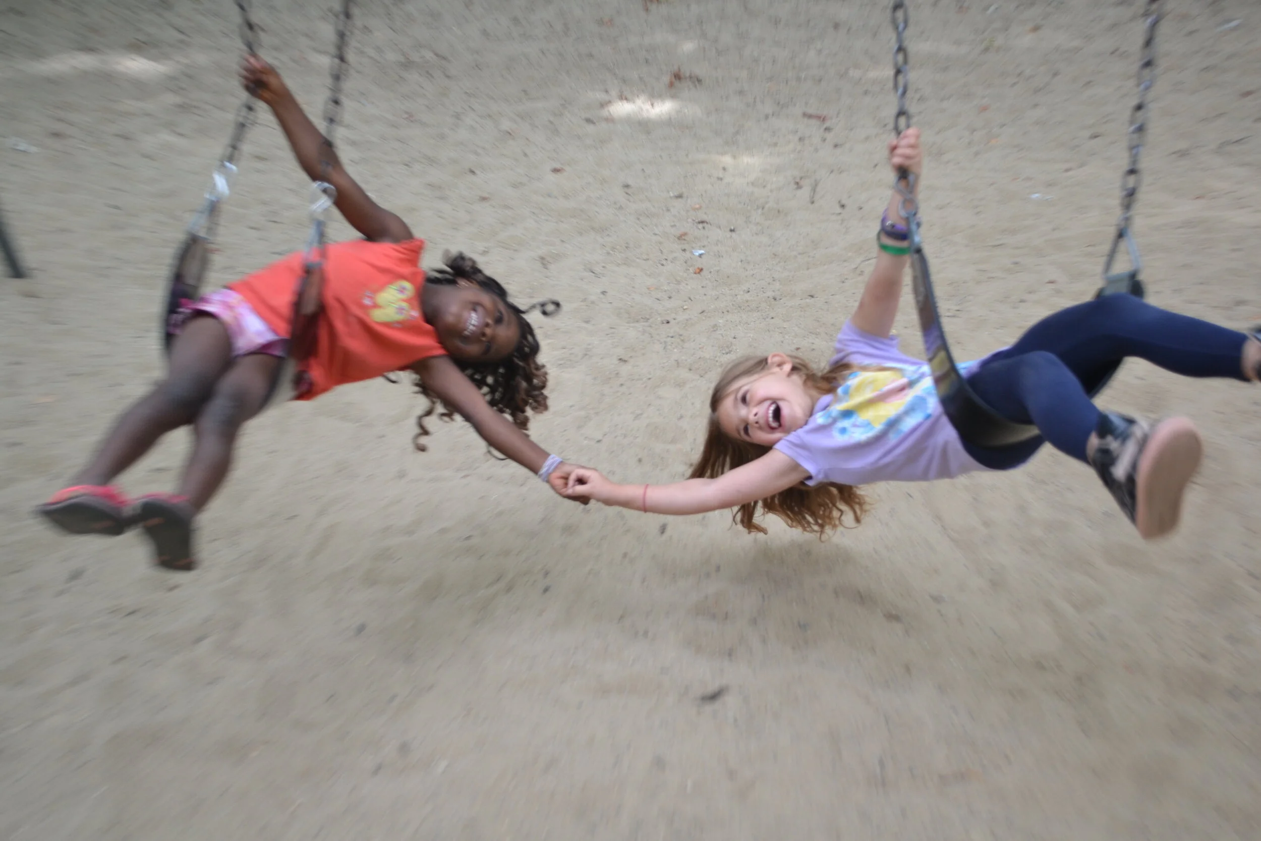 Two young people enjoy the swings at a Merrimack Valley Day Care facility. (Courtesy photo)