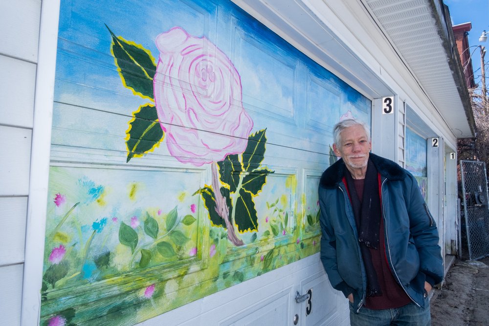  Anthony Williams of Manchester, artist and muralist,  poses with his murals painted over 2020-2021 for NeighborWorks. By Mark Bolton. 