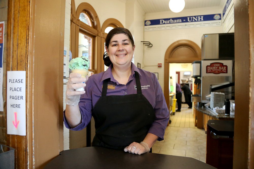  UNH Dairy Bar retail associate Diana Guy hands off a cone to guests Tuesday, June 14, 2022 in Durham. Olivia Falcigno/Seacoastonline 