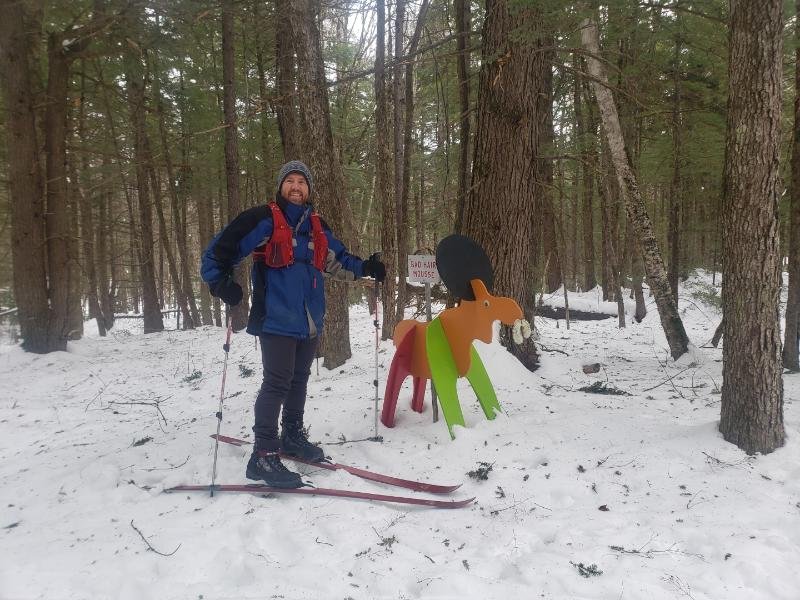  Skier Jamie Gillon of Hillsboro stops to take a break on the trails of the Pine Hill Ski Club next to the "Bad Hair Moose" Moosecot." Photo courtesy of Jamie Gillon 