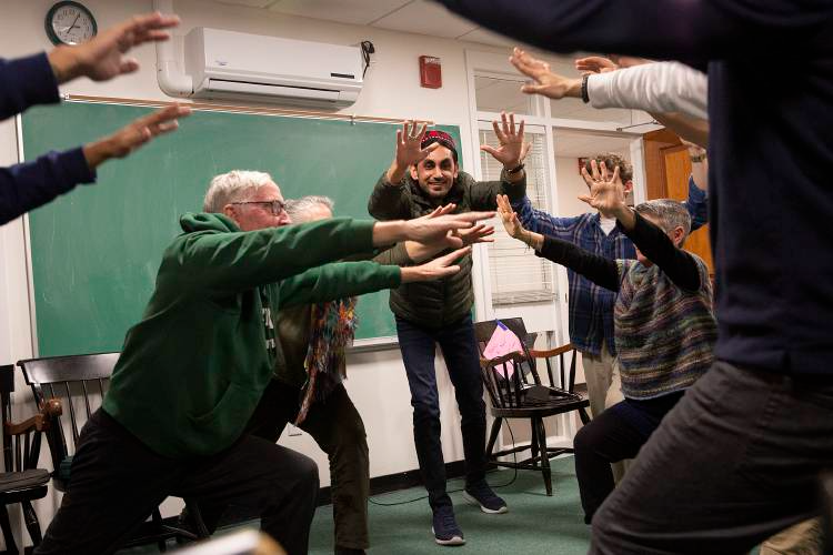  Abdullah Shah, center, participates in a weekly English class led by Helene Rassias-Miles, director of The Rassias Center at Dartmouth College, at Blunt Alumni Center in Hanover, N.H., on Thursday, Dec. 1, 2022. For nearly half his life, Shah, now 3