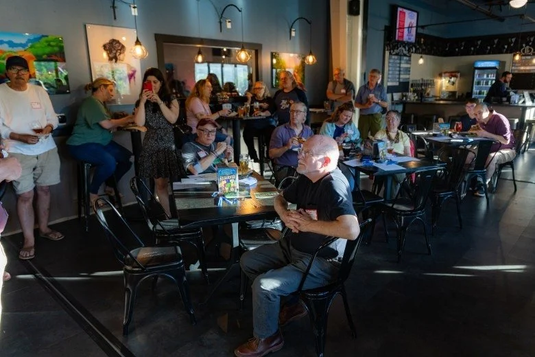  Members of the public listen to the opening remarks of the Publisher’s Crawl at Lithermans Limited Brewing Company on June 9, 2026 in Concord. Credit: ALEX MILLER / For the Monitor 