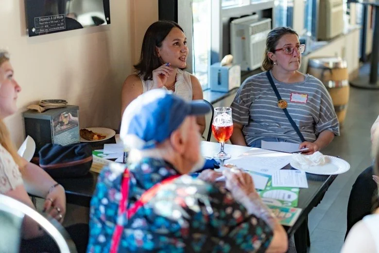  Monitor reporter Emilia Wisniewski leads a small group discussion with members of the public during the Publisher’s Crawl at Lithermans Limited Brewing Company on June 9, 2026 in Concord. Credit: ALEX MILLER / For the Monitor 