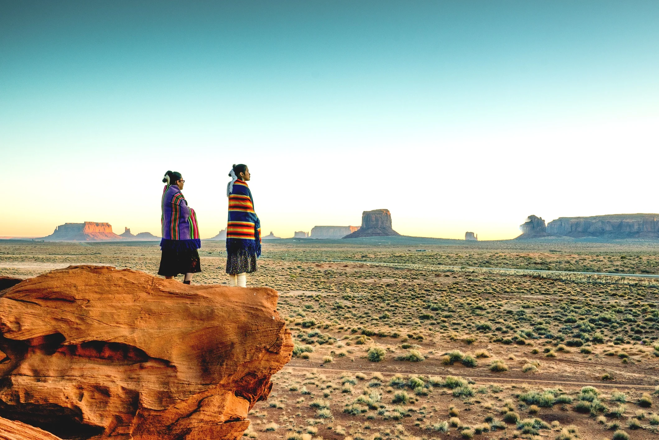 Navajo+sisters+looking+out+from+top+of+rock.jpg